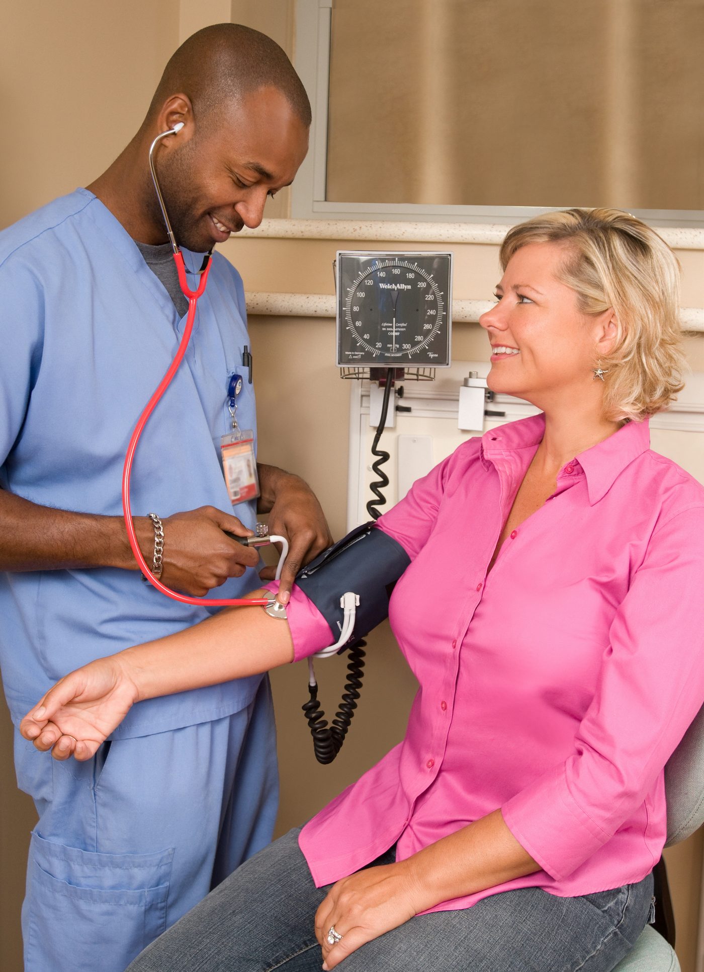 A nurse taking a patient’s blood pressure.