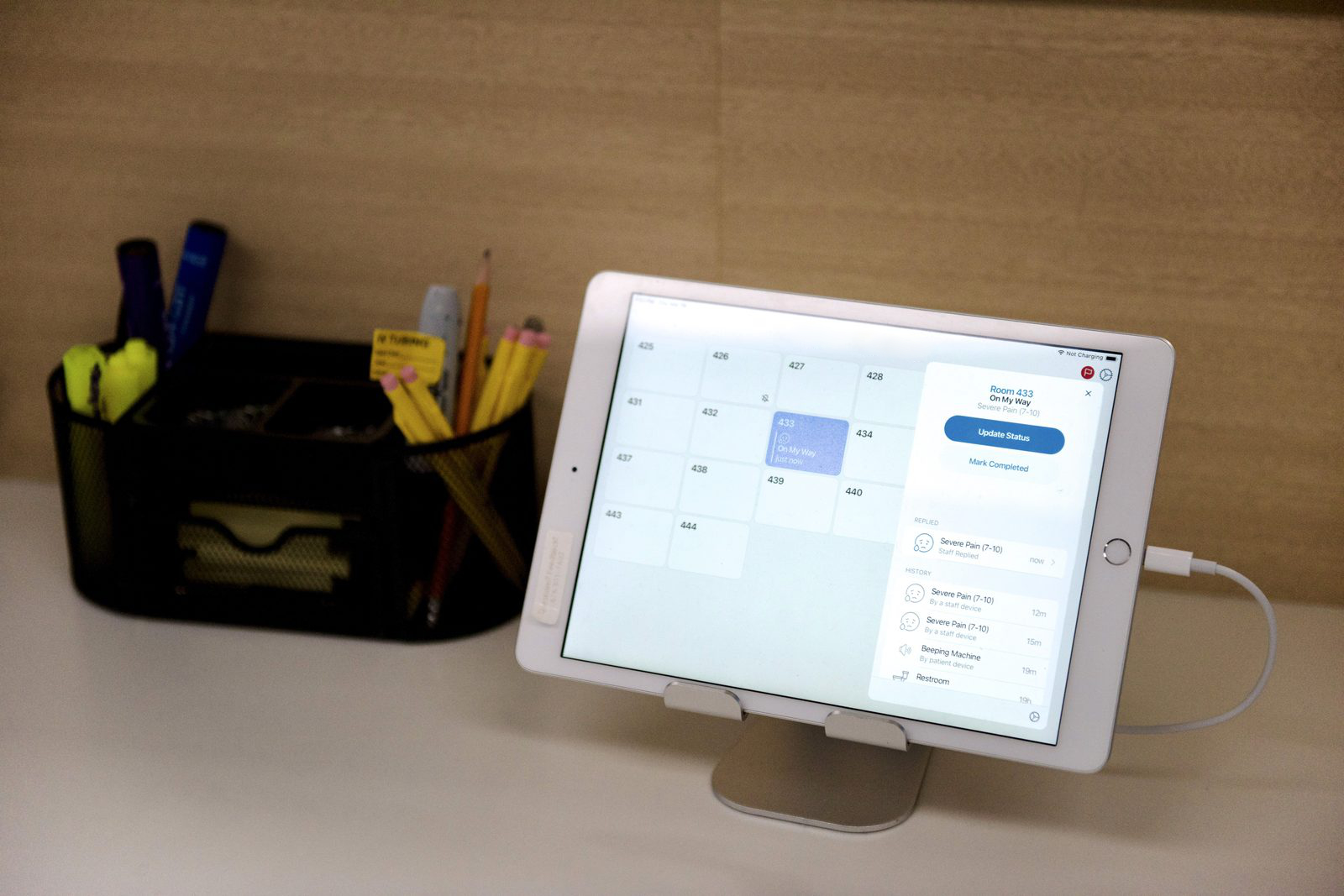 Tablet on a desk showing the Dispatch nurses-station view.